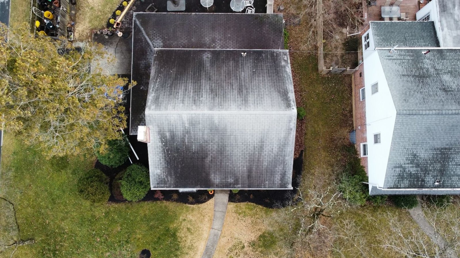 Before — top down drone view of severely worn addition roof, PA