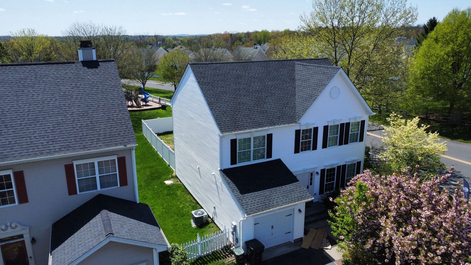 After — rear-left aerial of completed exterior renovation with new siding and roof — Shelby Roofing Services PA