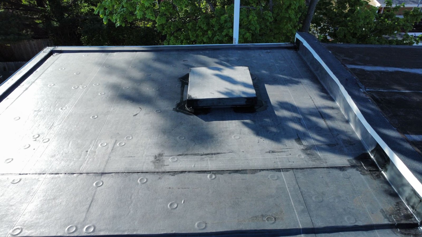 After — close-up of new EPDM flat roof membrane with scupper drain — Shelby Roofing Services PA