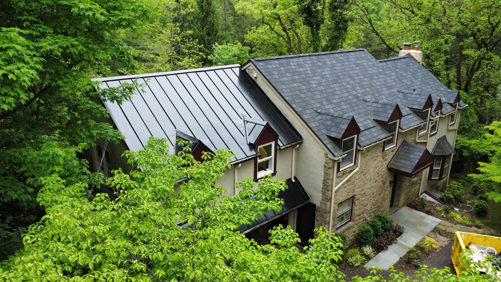 After — aerial view of completed home showing full metal and shingle roof combination — Shelby Roofing Services PA