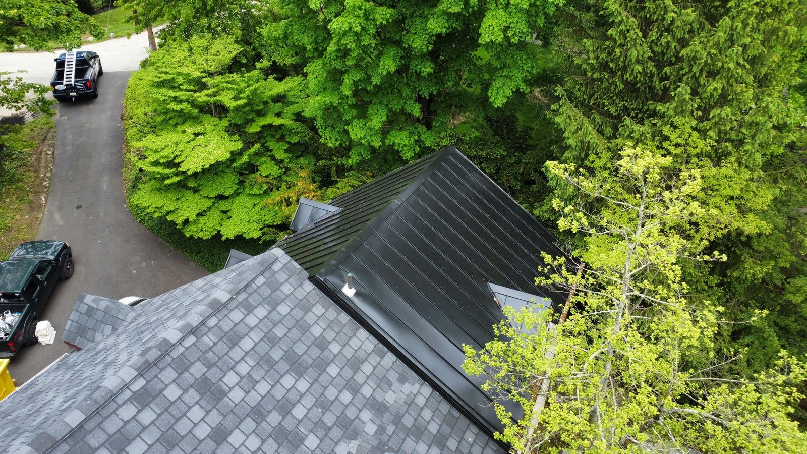 After — top-down aerial of completed standing seam metal roof with Shelby truck visible — Shelby Roofing Services PA