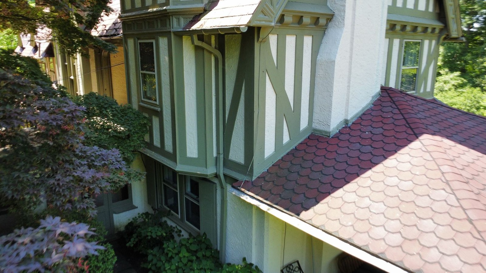 Before — bay window tower section with old plain gutters and downspout, Tudor home PA