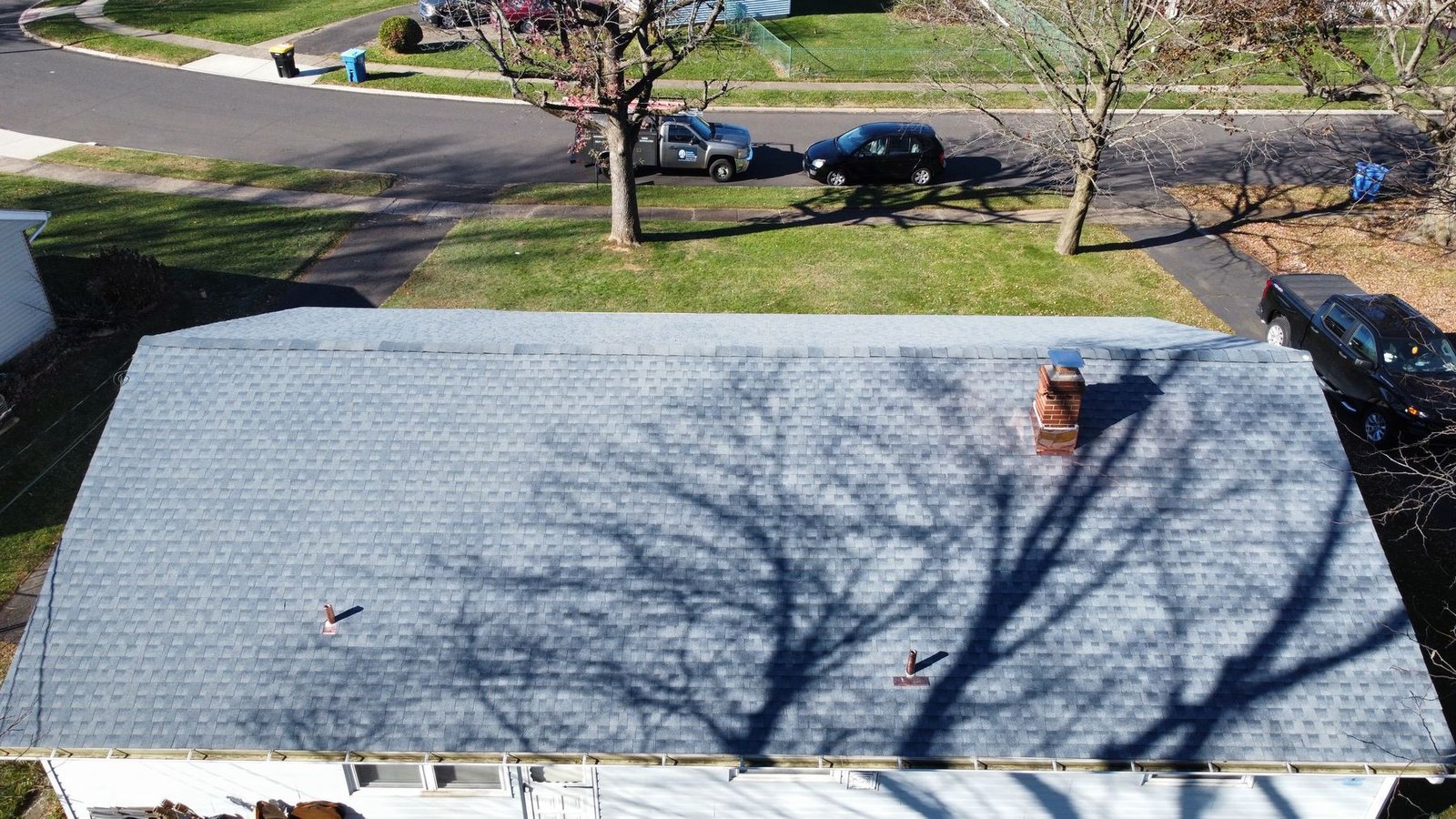 After — side angle drone shot of new shingles on ranch home — Shelby Roofing Services PA