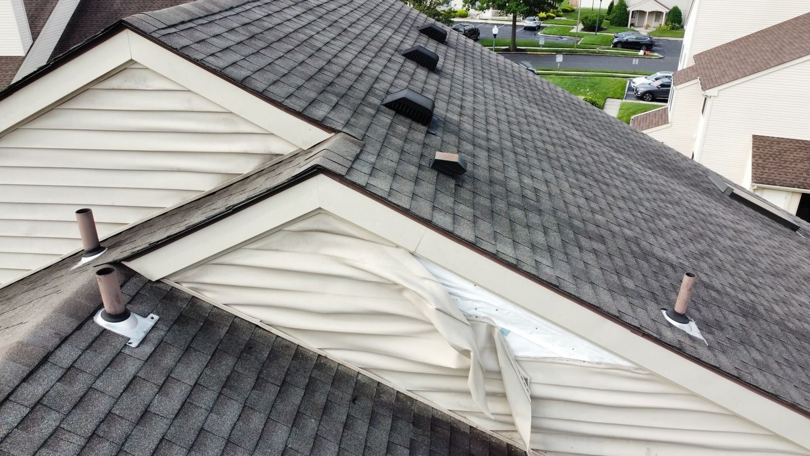Before — close aerial of storm-damaged condo roof, PA