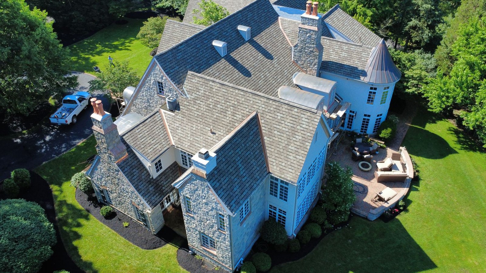 Stone mansion with premium slate and copper roofing — Shelby Roofing Services PA
