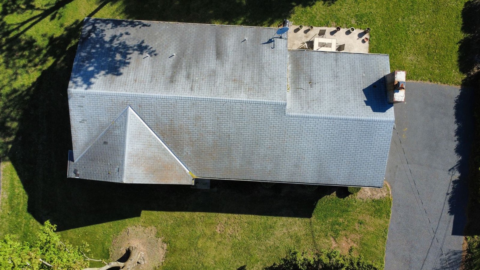 Before — front aerial of ranch home with worn gray shingles, PA