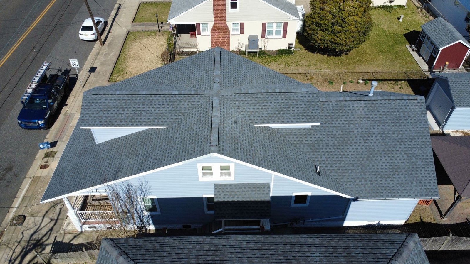 After — front aerial of Cape Cod with new dark shingles — Shelby Roofing Services NJ