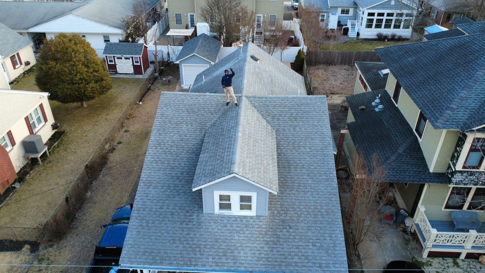 Before — front aerial of Cape Cod beach home with old shingles, NJ