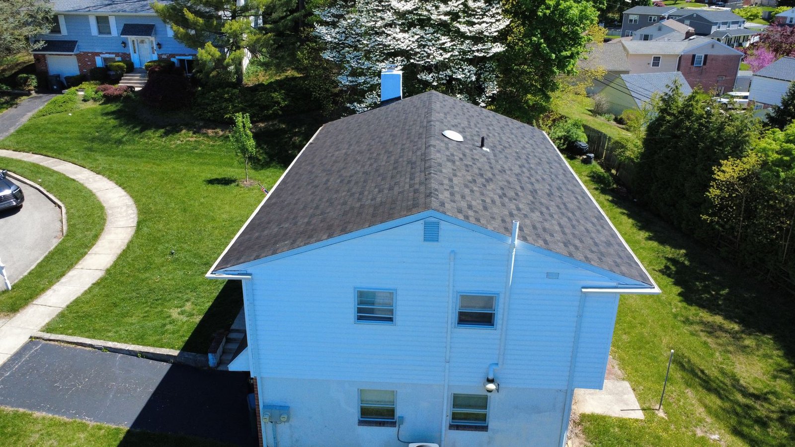 Before — aerial view of split-level brick home with old roof, PA