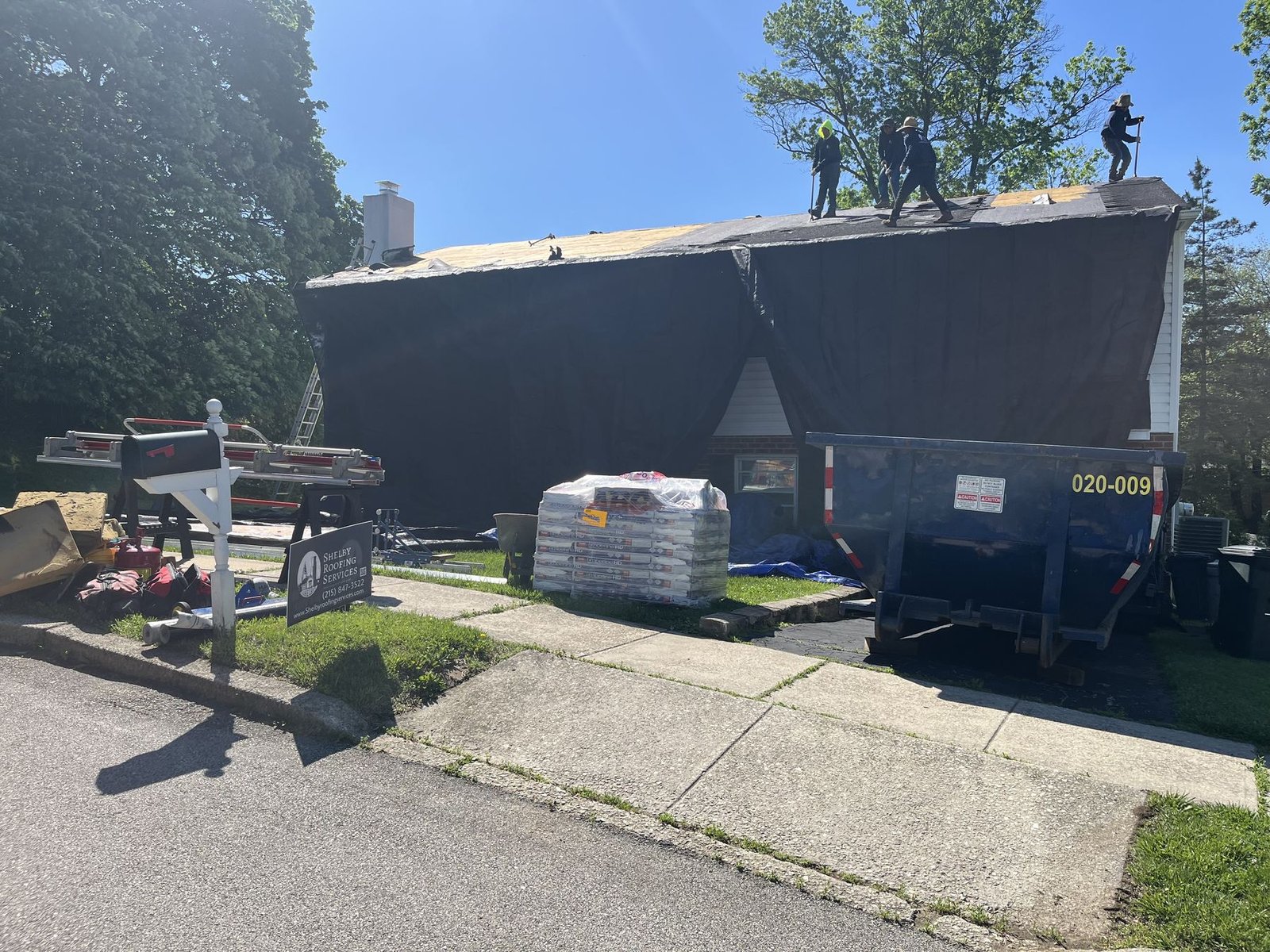 In-progress — Shelby crew tearing off and installing roof on split-level, PA