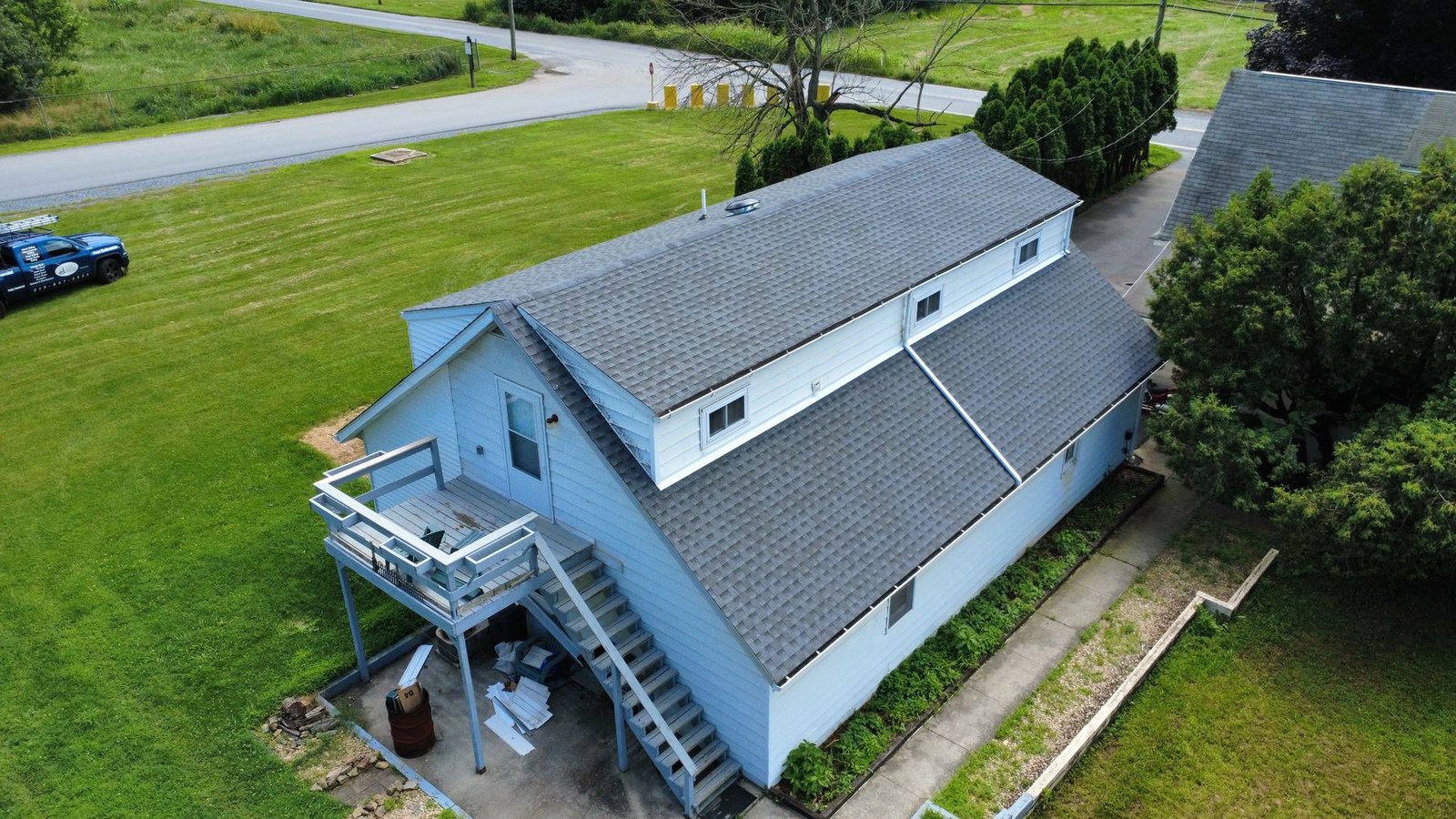 After — side aerial of white ranch with new gray shingles — Shelby Roofing Services PA