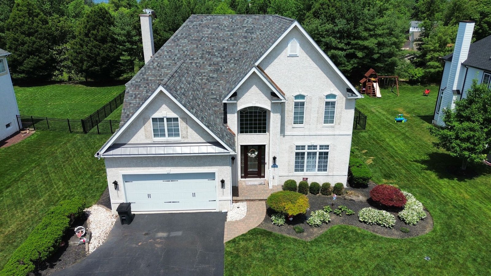 After — front facade of stucco home with completed architectural shingle replacement — Shelby Roofing Services PA