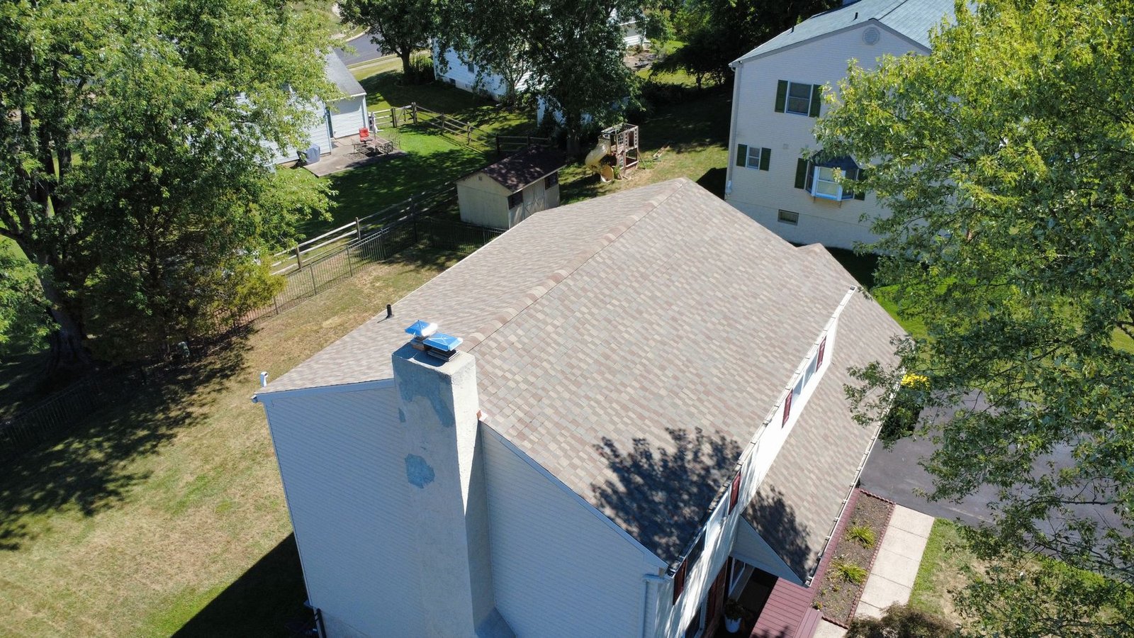After — top-down aerial of colonial with new architectural shingles — Shelby Roofing Services PA