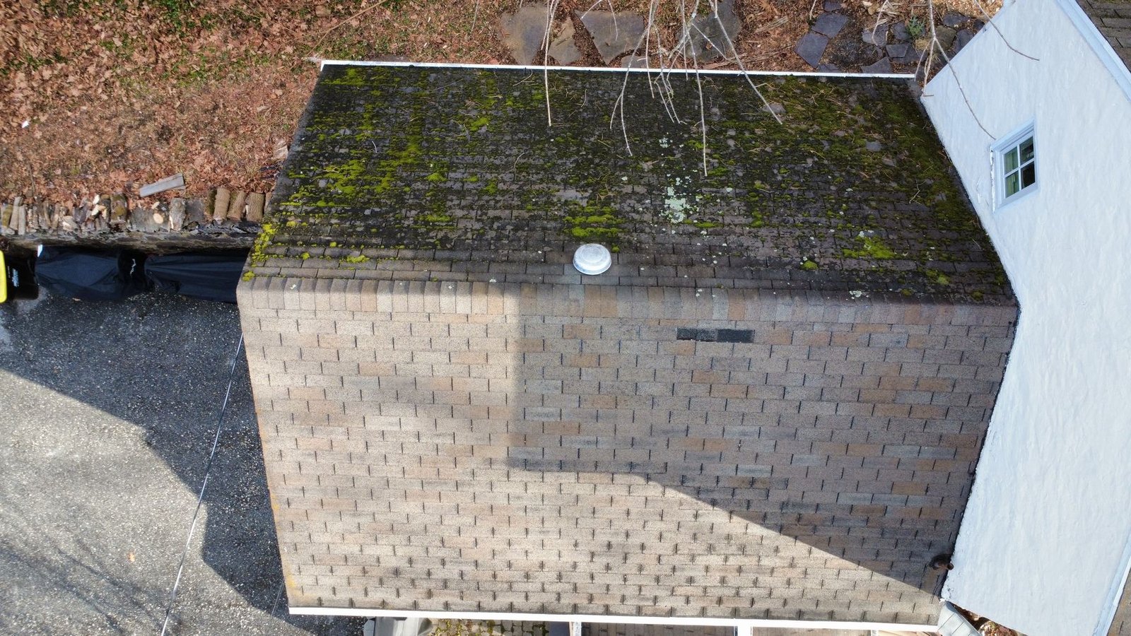 Before — aerial of white cottage with moss-damaged shingles, PA