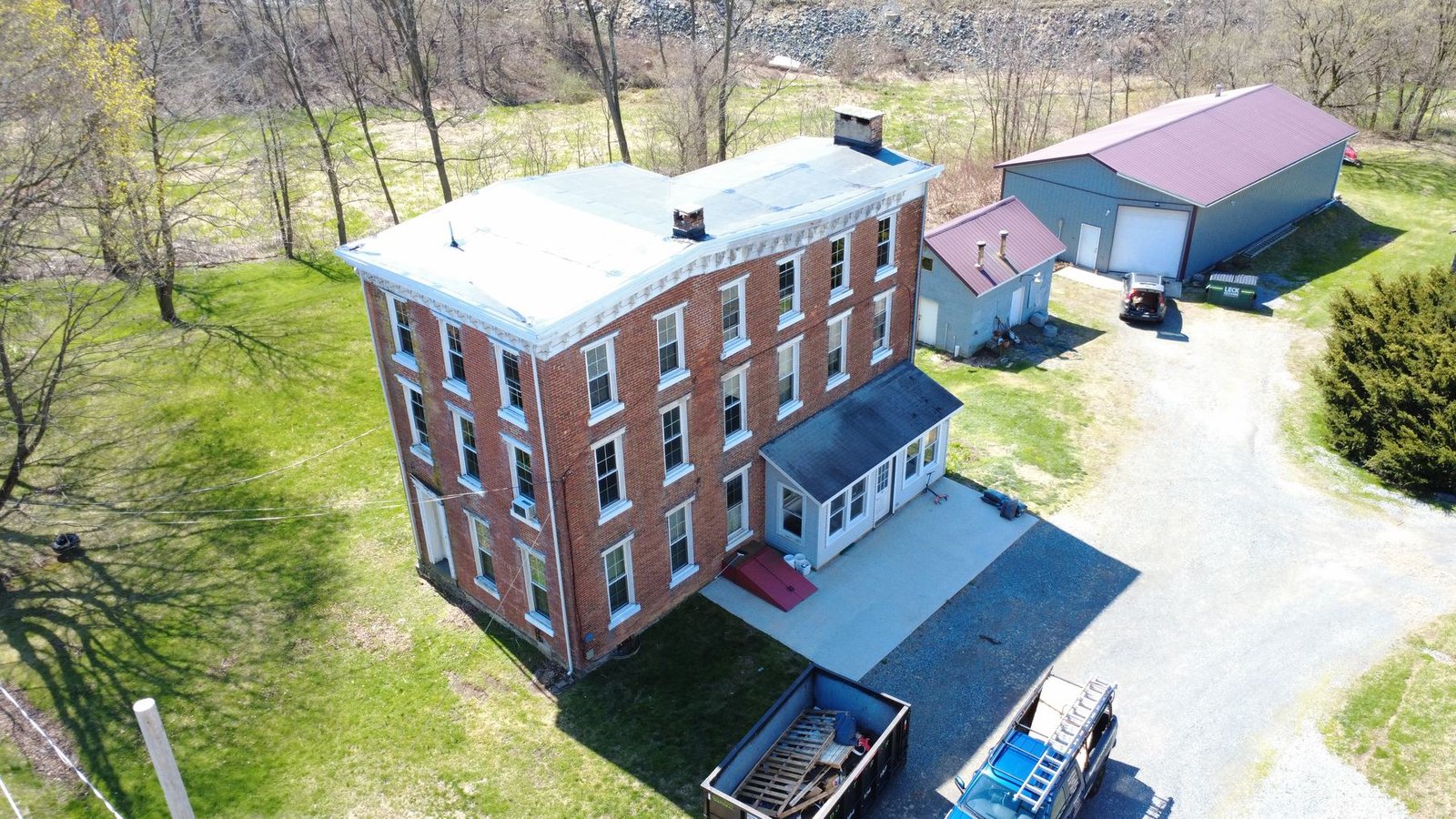 After — aerial of historic brick building with new black EPDM flat roof — Shelby Roofing Services PA