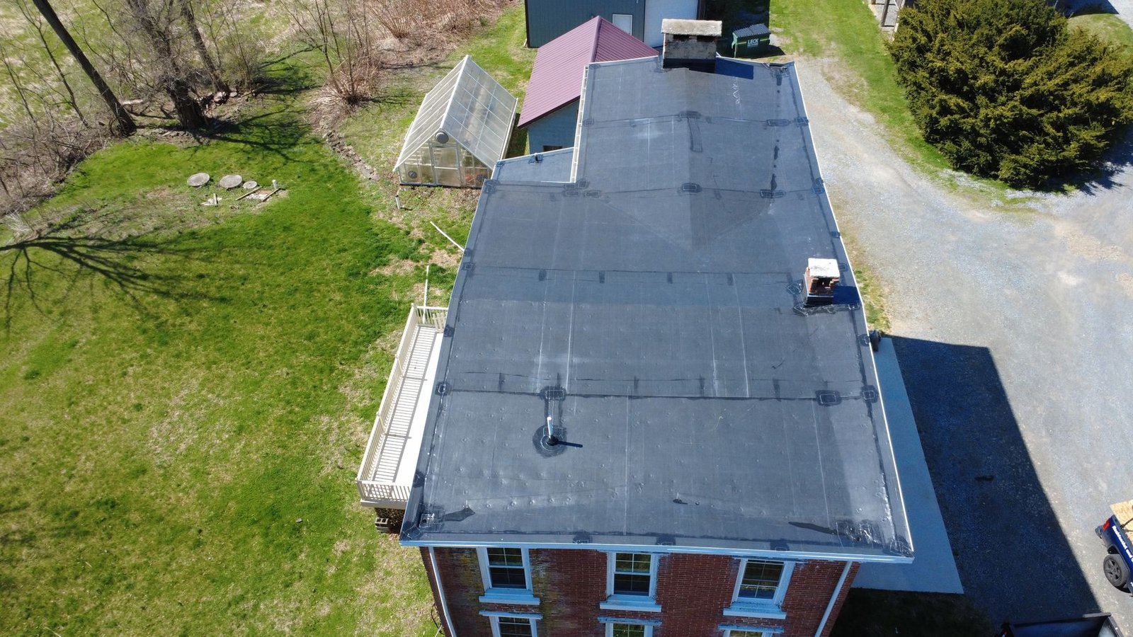 After — top-down aerial of historic brick building with new EPDM flat roof — Shelby Roofing Services PA