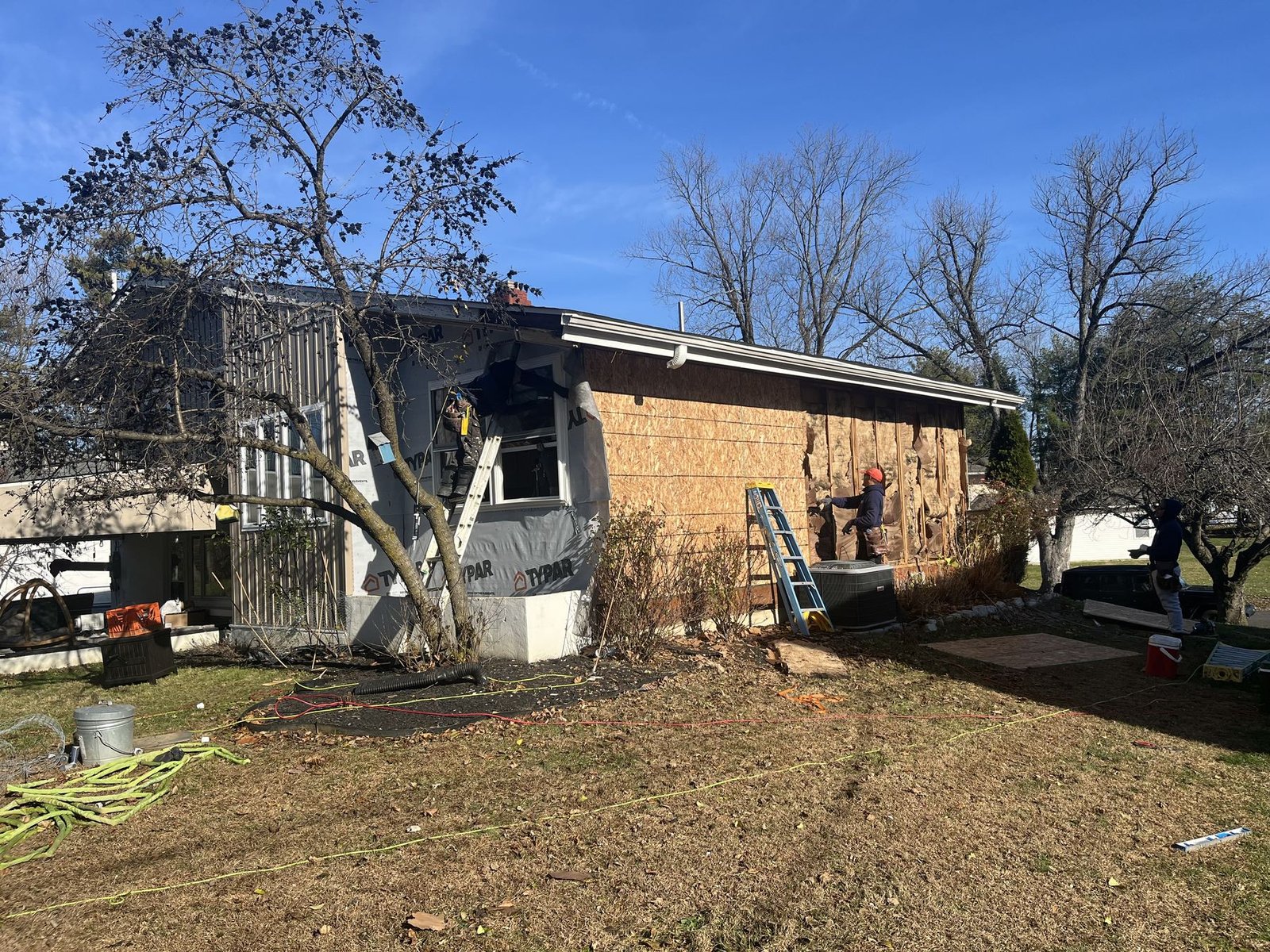 Before — street-level view of ranch with storm damage and siding removed, PA