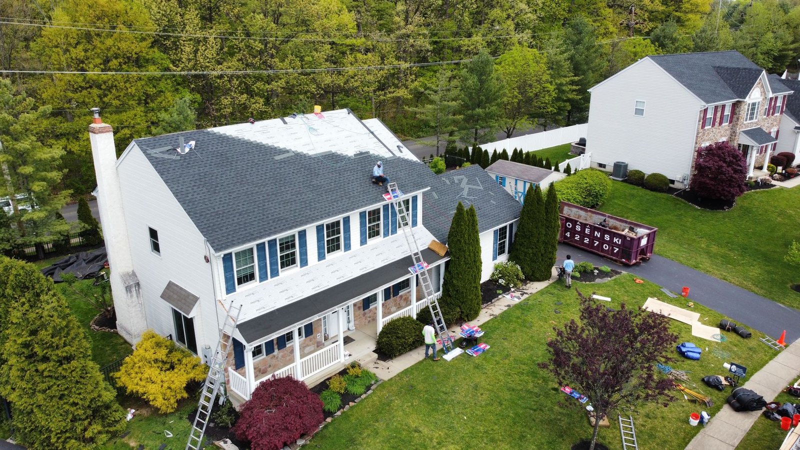 Shelby Roofing Services crew mid-installation — tear-off and re-roof in progress, PA