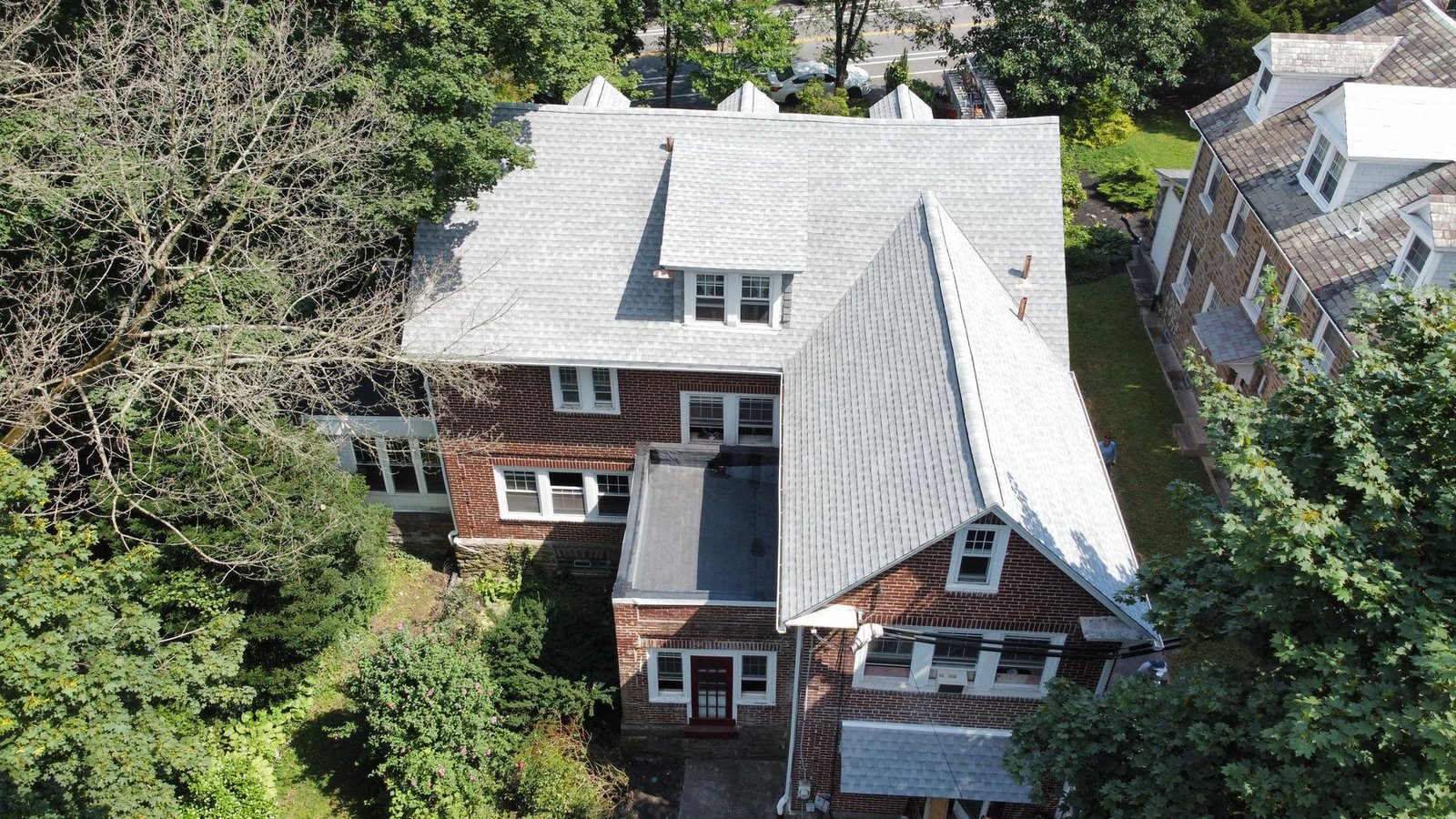 After — front-left aerial showing new architectural shingles and dormers — Shelby Roofing Services PA