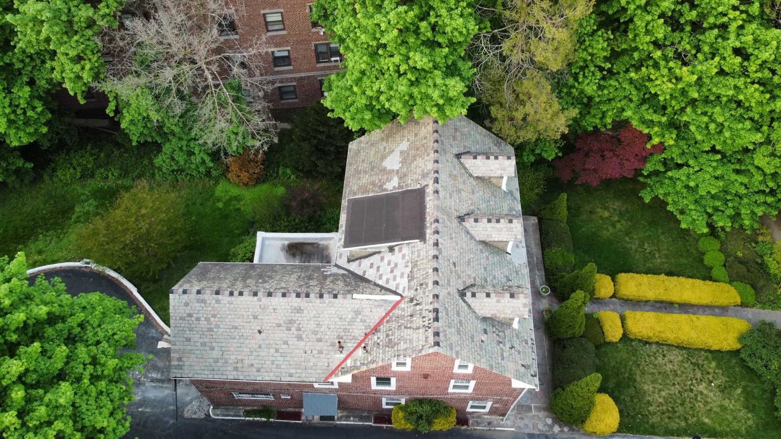 Before — top down drone view of worn shingle roof on brick colonial, PA