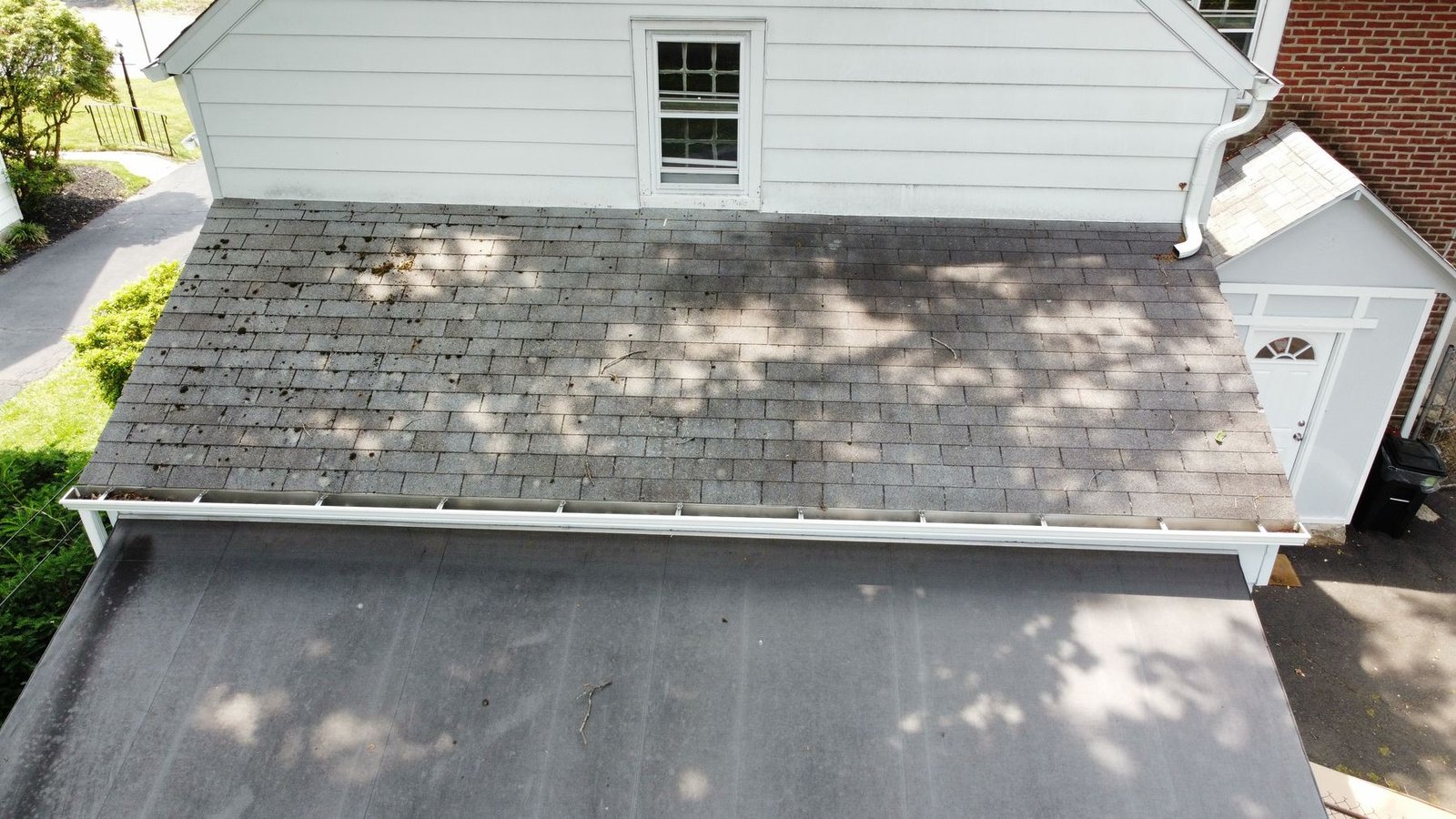 Before — carport and lower roof section with severely weathered shingles, PA