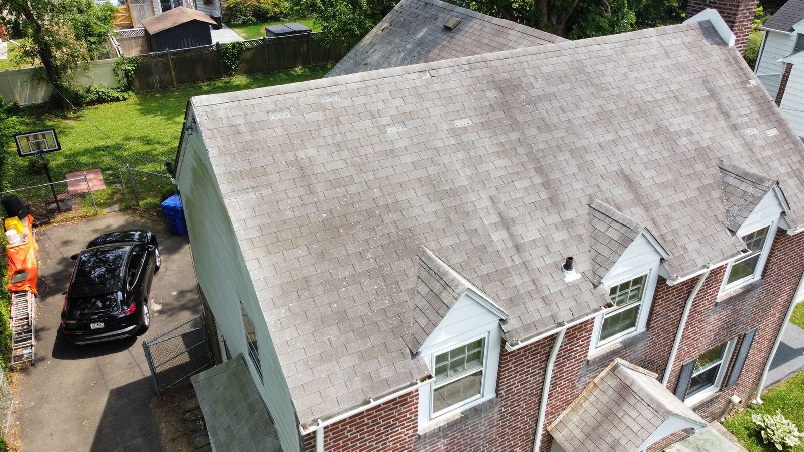 Before — rear aerial showing old shingles with Shelby Roofing crew on site, PA