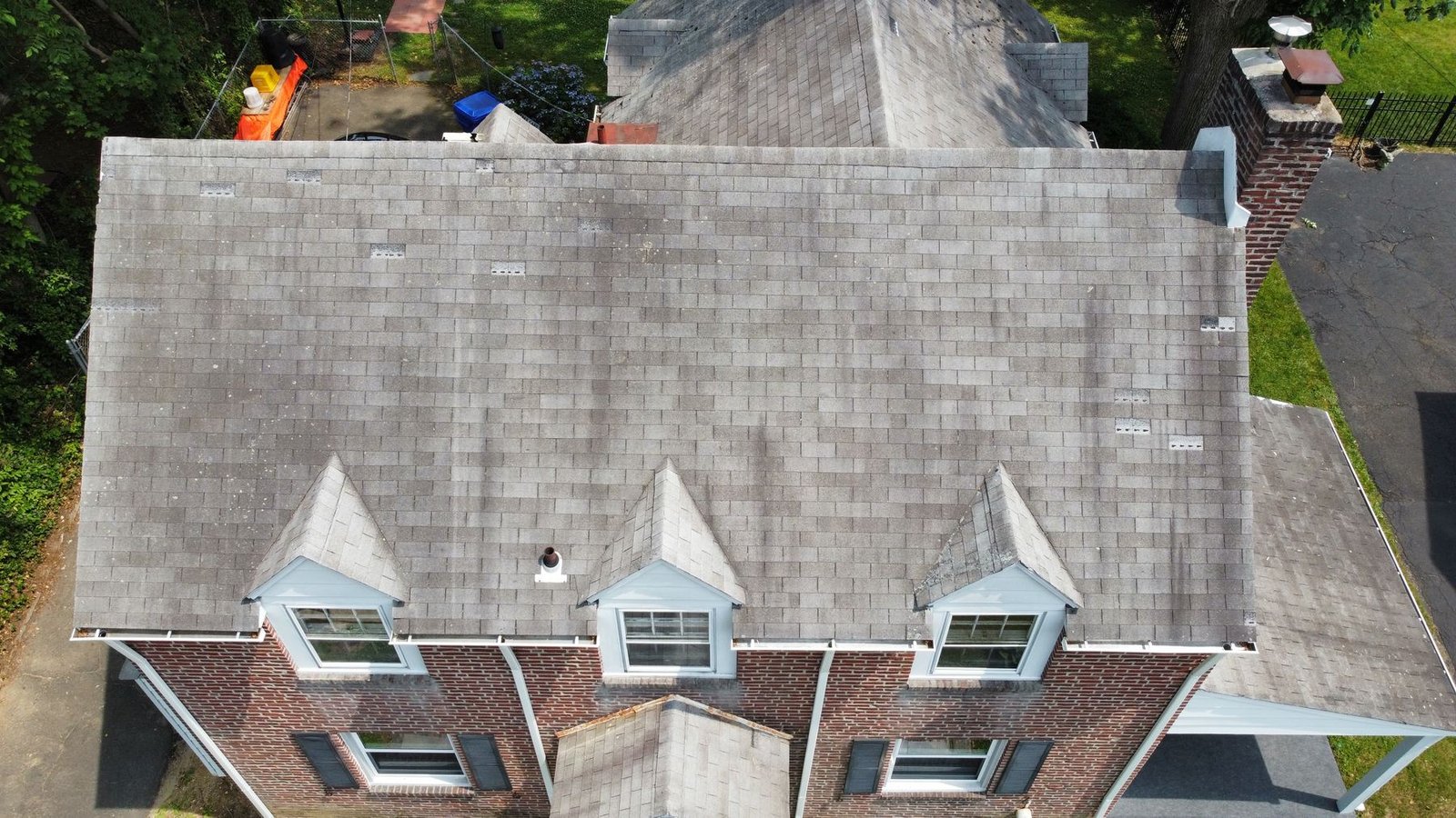 Before — top-down aerial showing 3 dormers and algae-stained shingles, PA