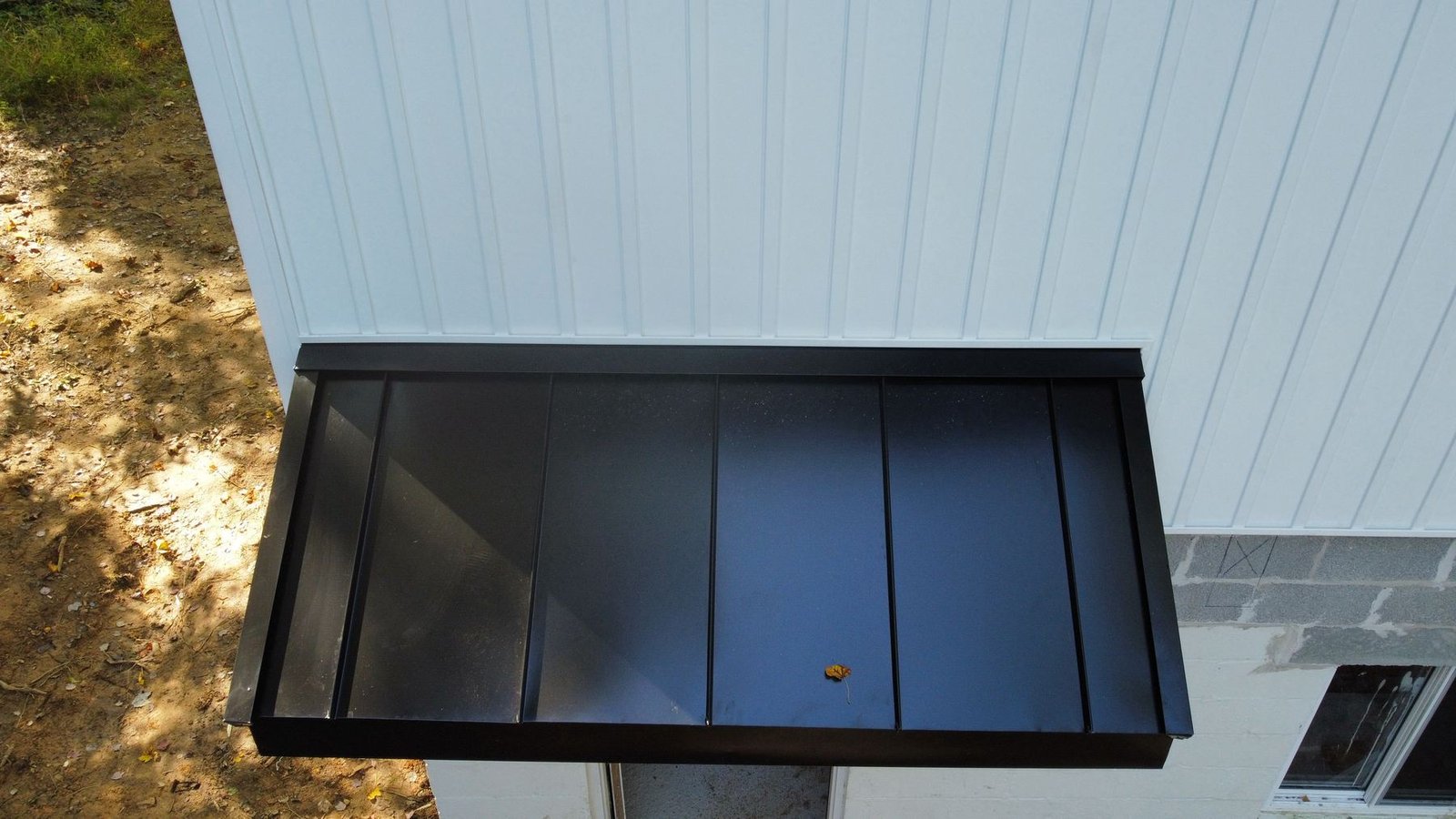 After — top-down close-up of new standing seam metal awning in charcoal finish — Shelby Roofing Services PA