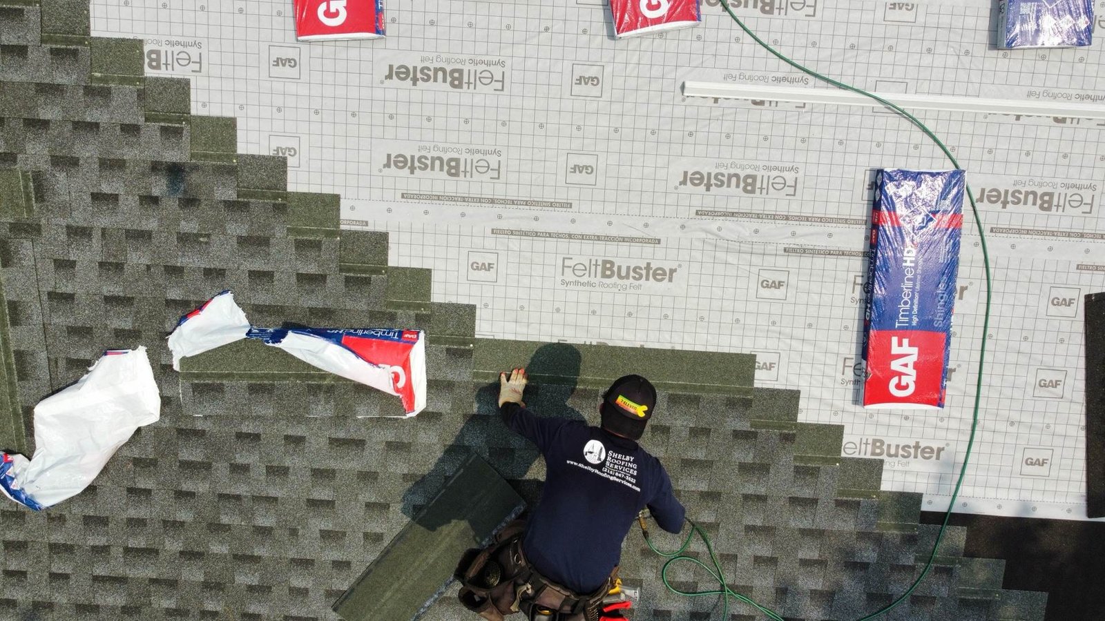 Shelby Roofing Services installer laying GAF shingles — precision installation