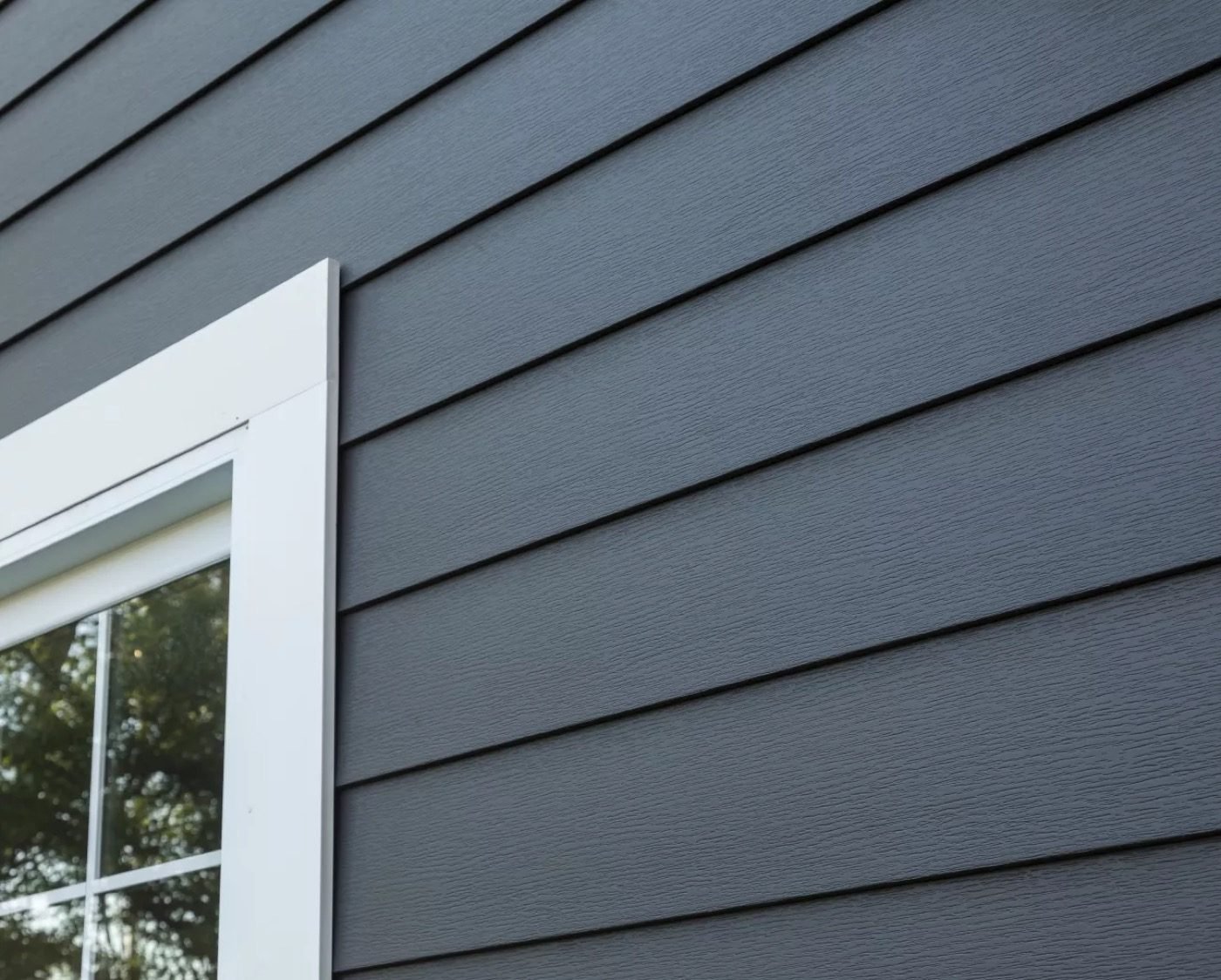 Fiber cement lap siding in dark gray — Shelby Roofing Services